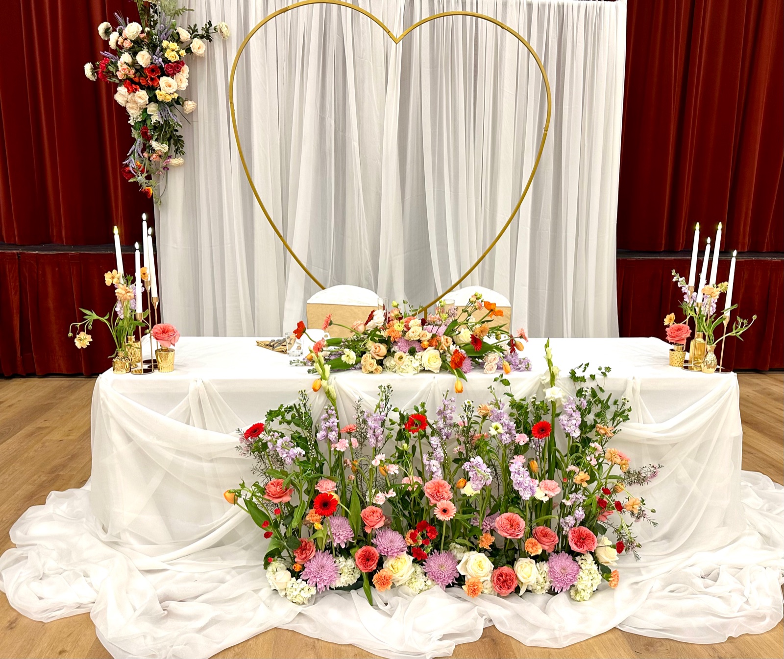 Floral wedding head table on the Great Hall stage